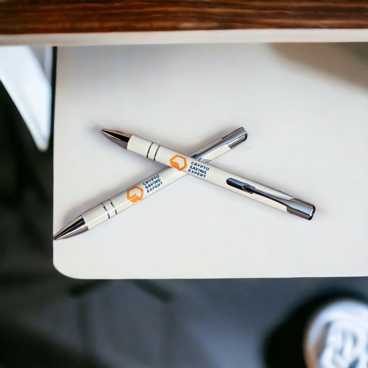 Official CSE Logo Pen on table crossed | Ballpoint Pen crossed | Stationary on desk